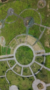 Vertical screen, Vietnam, Da Nang Aerial Circular Park Da Nang Vietnam Overhead Drone View Showing Radial Pathways Central Lawn Segmented Plazas Concrete Walkways Scattered Trees Green