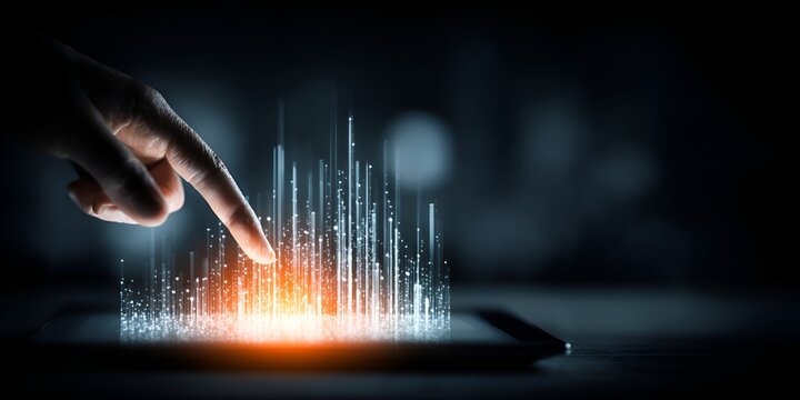 A finger touches glowing digital lines emerging from a dark screen representing technology innovation and advanced user interaction interface.