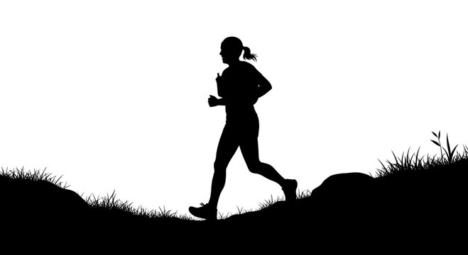 Active woman trail running on a grassy landscape silhouette