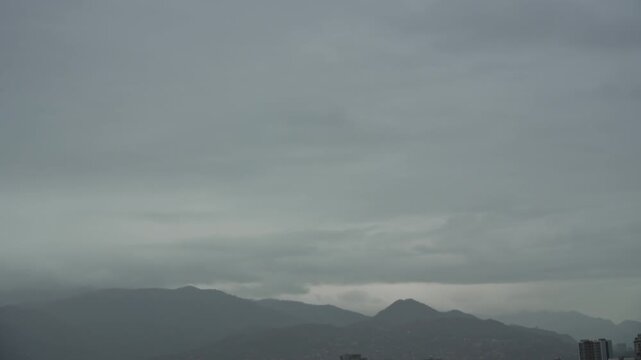 Timelapse moving thunderclouds before storm, view of the mountains. Stormy weather, melancholy, depression. City life timelapse