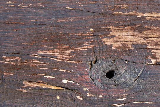 Rustic Wooden Plank with Dark Knothole and Weathered Wood Texture