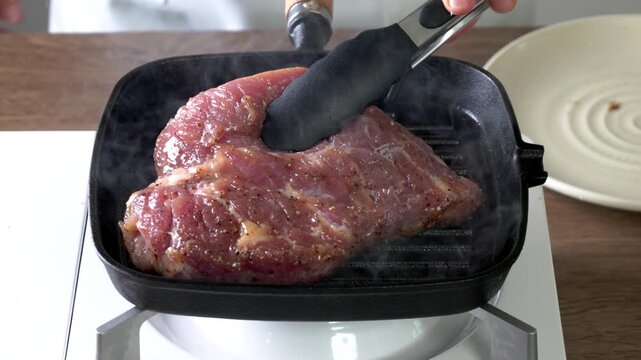 Grilled meat in a cast iron pan.
