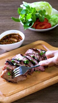 Grilled Beef Brisket with Jaew Sauce wooden cutting board