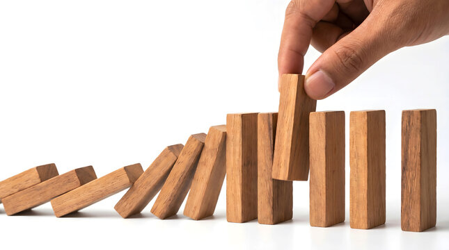 Hand stopping domino effect business strategy and risk management concept management business strategy prevention