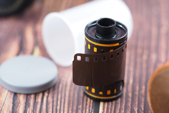 Film roll and canister placed on wooden table