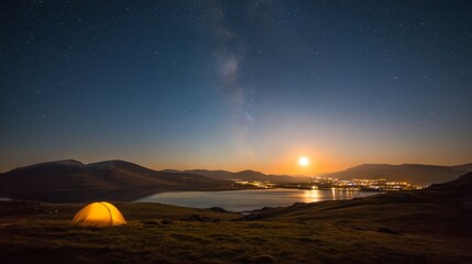 Obraz premium Camping tent under milky way beside lake at night with glowing horizon lights. Starry sky, tranquil wilderness and long exposure landscape create peaceful outdoor adventure