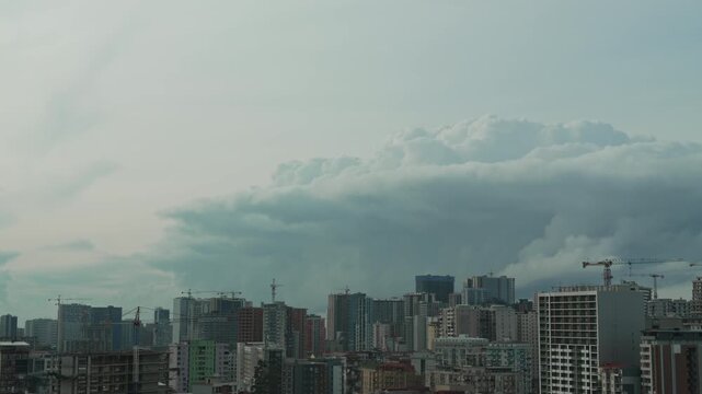 Dramatic storm clouds is approaching the city. Thunderstorm warning, climate change, environmental protection. Problem of urban air pollution