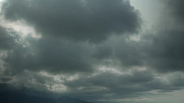 Timelapse of clouds sky are scudding over mountains. Storm warning, climate change, environmental protection. Problem of urban air pollution