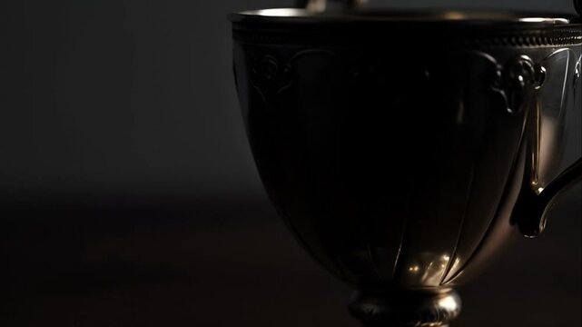 Closeup of antique metal trophy cup.