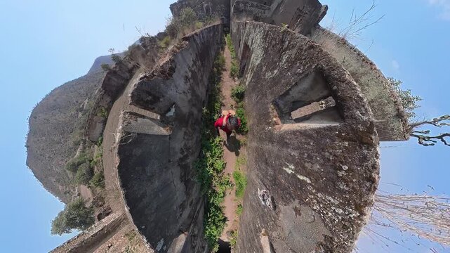 Explorer discovering abandoned ruins tiny planet effect