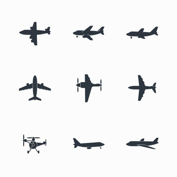 Collection of various airplane silhouettes flying.