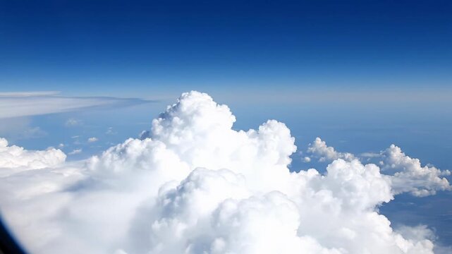 Breathtaking 4k cinematic timelapse of fluffy white clouds drifting across a deep sapphire blue sky captured from a high altitude drone view minimalist cool color grading for