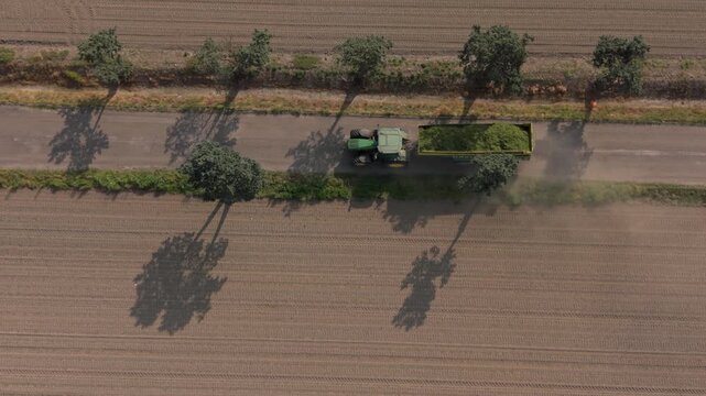 Silage transfer between tractors field aerial view