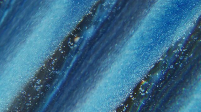 Ink wave defocused. Lens fluid. Glitter stripe trickles stream mix color abstract background. Blue black particles spill with prism effect.