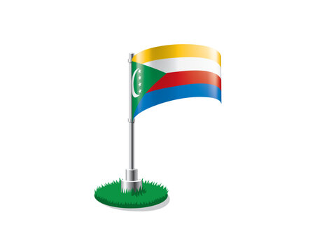 Comoros flag on a flagpole mounted on the grass