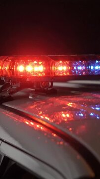 Flashing red and blue police car lights at night