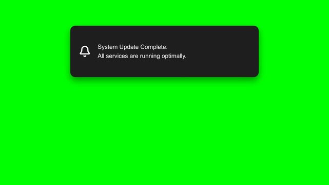 A notification text appears in a motion click on a green screen with a black box showing a system update complete message