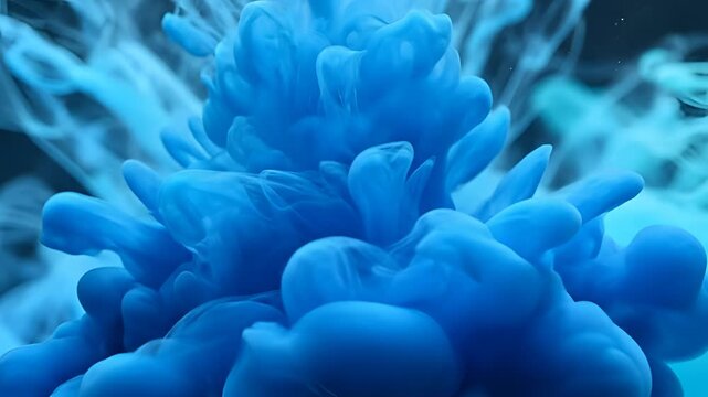 Abstract Blue Ink Cloud Explosion Underwater Macro Shot.