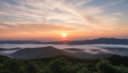 Naklejka premium Sunrise over misty mountains with fog in valley landscape
