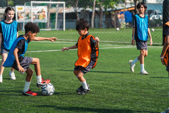 World cup concept with soccer ball or football player, children soccer practice youth sport outdoor field teamwork competition training ball control goalkeeper net green grass school game