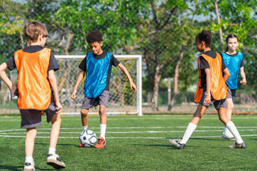 Fototapeta premium World cup concept with soccer ball or football player, youth soccer players practice on outdoor field with goal in sunny park