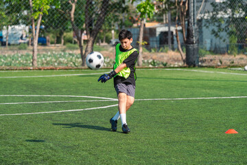 Obraz premium World cup concept with soccer ball or football player, youth soccer player kicking ball on outdoor field