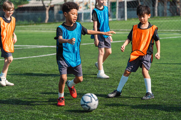 World cup concept with soccer or football player, youth soccer practice children soccer field team sports training ball school outdoor © chokniti
