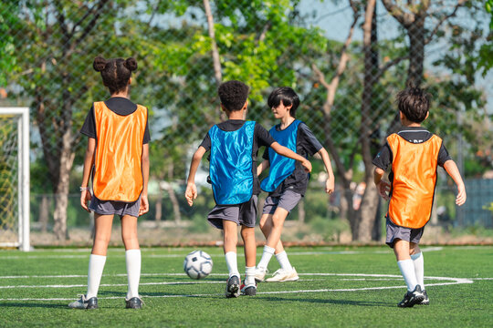 World cup concept with soccer or football player, children soccer practice on outdoor field, youth sport teamwork and training