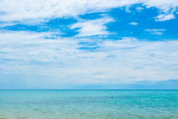 Fototapeta premium Tropical Nature clear sky and summer sea water under a clear blue sky with beautiful clouds and bright sunlight. Perfect for summer vacation and travel background 