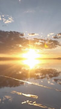 Salar de Uyuni in Bolivia during sunset. Aerial image Rainy Season.Time lapse in vertical video