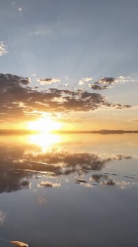 Salar de Uyuni in Bolivia during sunset. Aerial image Rainy Season.Time lapse in vertical video