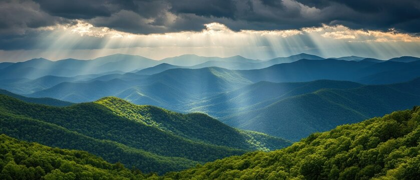 Sunbeams over majestic mountain ranges green hills and dramatic cloudscape