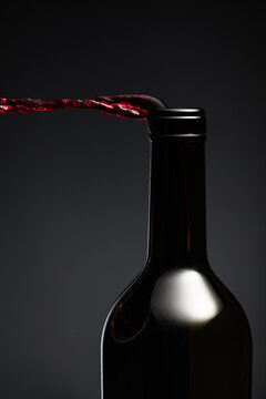 Red wine pours out of the bottle.