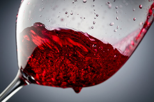 Red wine is poured into a glass.