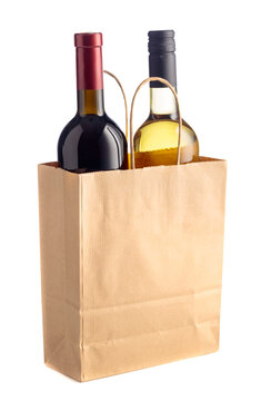 Bottles of red and white wine in paper bag isolated on a white background.