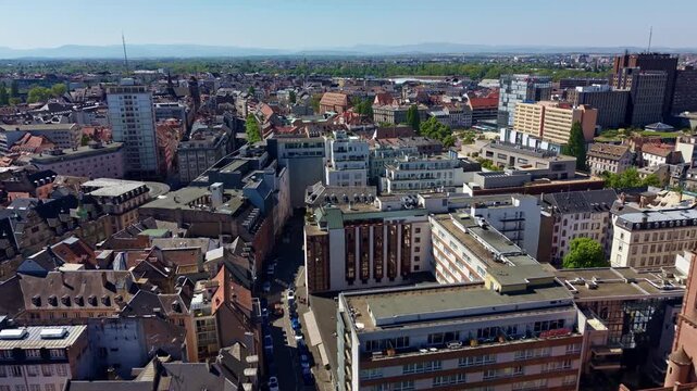 Drone flying beside Saint Pierre le Jeune above Strasbourg city center