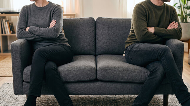 Couple Having Argument on Living Room Sofa

