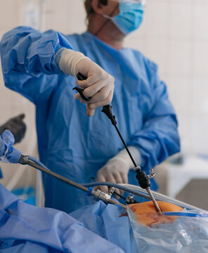 Surgeons performing laparoscopic abdominal surgery with endoscopic tools