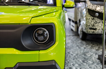 Close-up of the round headlamps of a car. Intricate details of a contemporary car. © NastyaPhoto
