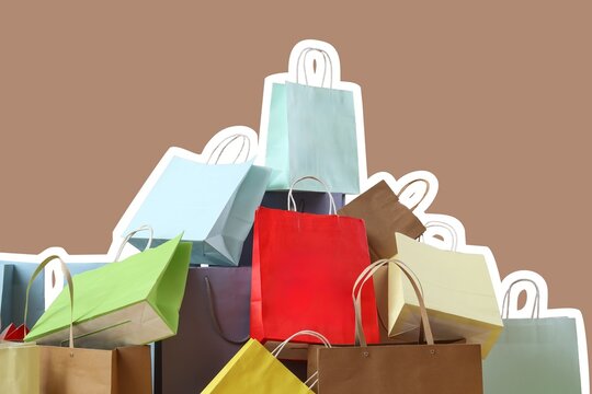 Heap of many different shopping bags on brown background