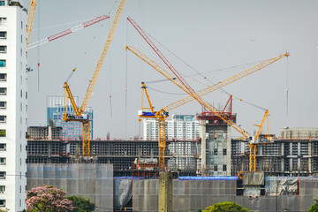 Large urban construction site with multiple tower cranes and high-rise buildings in the city, representing real estate development, infrastructure expansion and rapid urbanization. © All times 