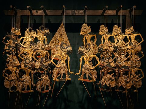 Traditional Indonesian Wayang Kulit Shadow Puppet Intricate Gold Detail Dark Background