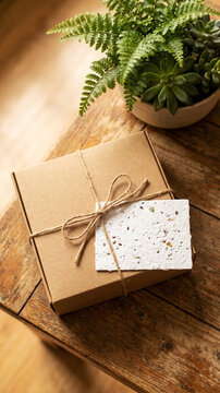 Eco friendly cardboard gift box with twine and handmade card on wooden table