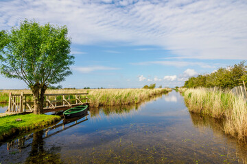 The Rozé Canal with traditional barges in the Brière Nature Park, France © serge