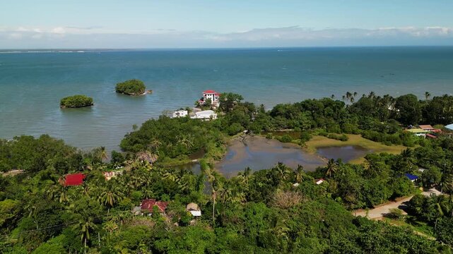 Picturesque aerial view of coastal landscape in Buenavista, Guimaras, Philippines with tropical vegetation, shoreline, and surrounding ocean