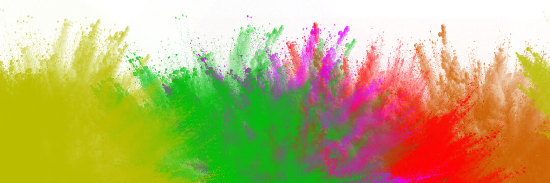 Vibrant multi colored powder explosion captured in a high speed action photograph showing festive particles floating on transparent background