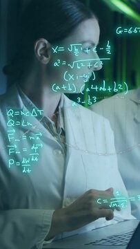 Vertical video: Scientist touching laptop while cyan formulas reacting on glass, analyzing lab data