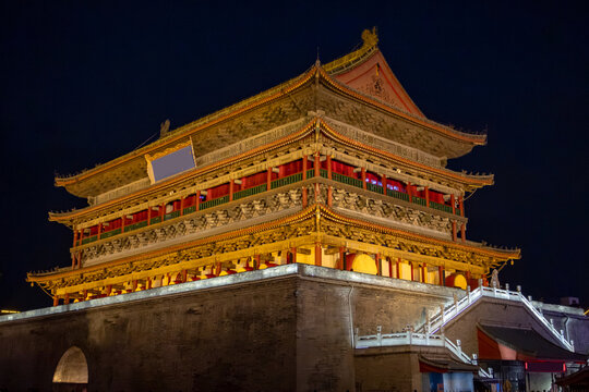 Historic bell tower stands illuminated at night in the center of Xi'an showcasing ancient Chinese architecture and cultural significance