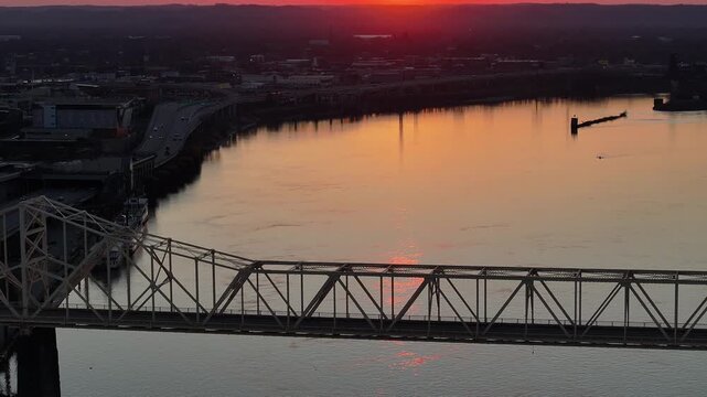 Aerial view of the George Rogers Clark Bridge over the Ohio River at sunset with the city skyline in the background Louisville, Kentucky, United States.