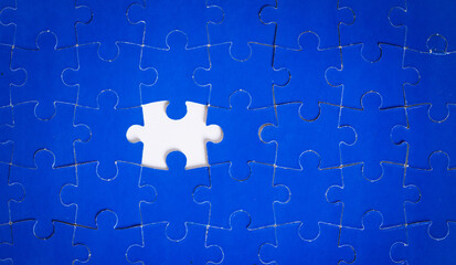 Fototapeta premium Blue puzzle nearly complete, one piece missing 